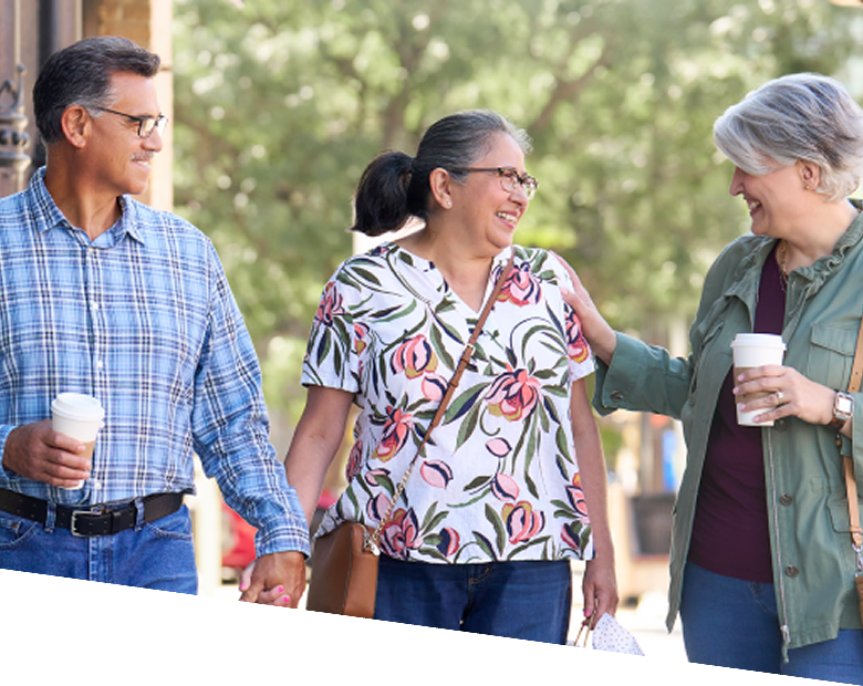 Three adults walking outdoors