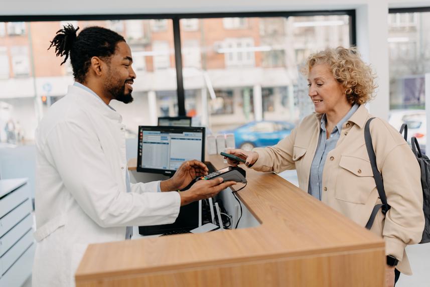 A woman paying at a pharmacy