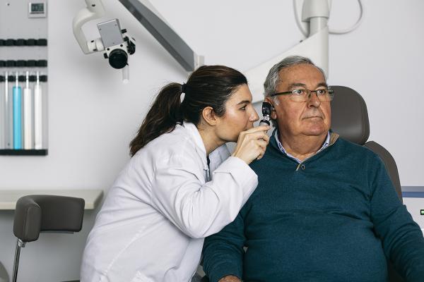 Doctor looking into a patients ear