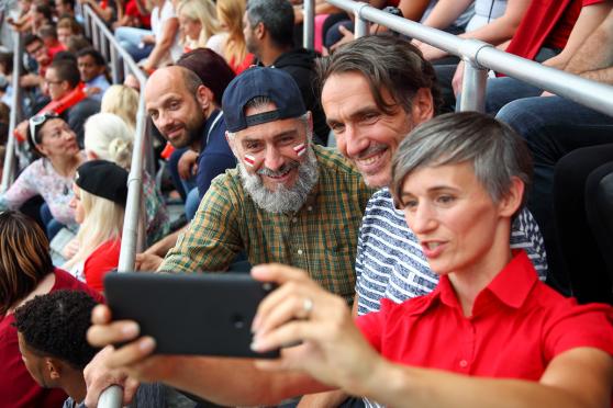 A group of friends taking a selfie at a sports stadium