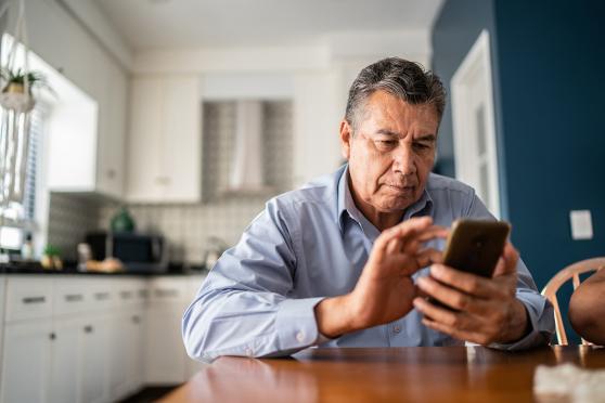 A man scrolling through a smartphone