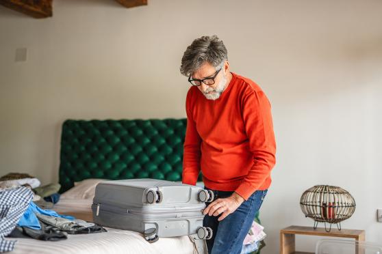 A man packing a suitcase